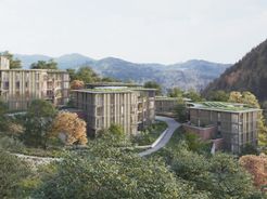 La fachada y apariencia de los edificios multifamiliares en el proyecto Sonnhalde en Waldkirch se integra con la estructura del bosque mediante un revestimiento de madera vertical