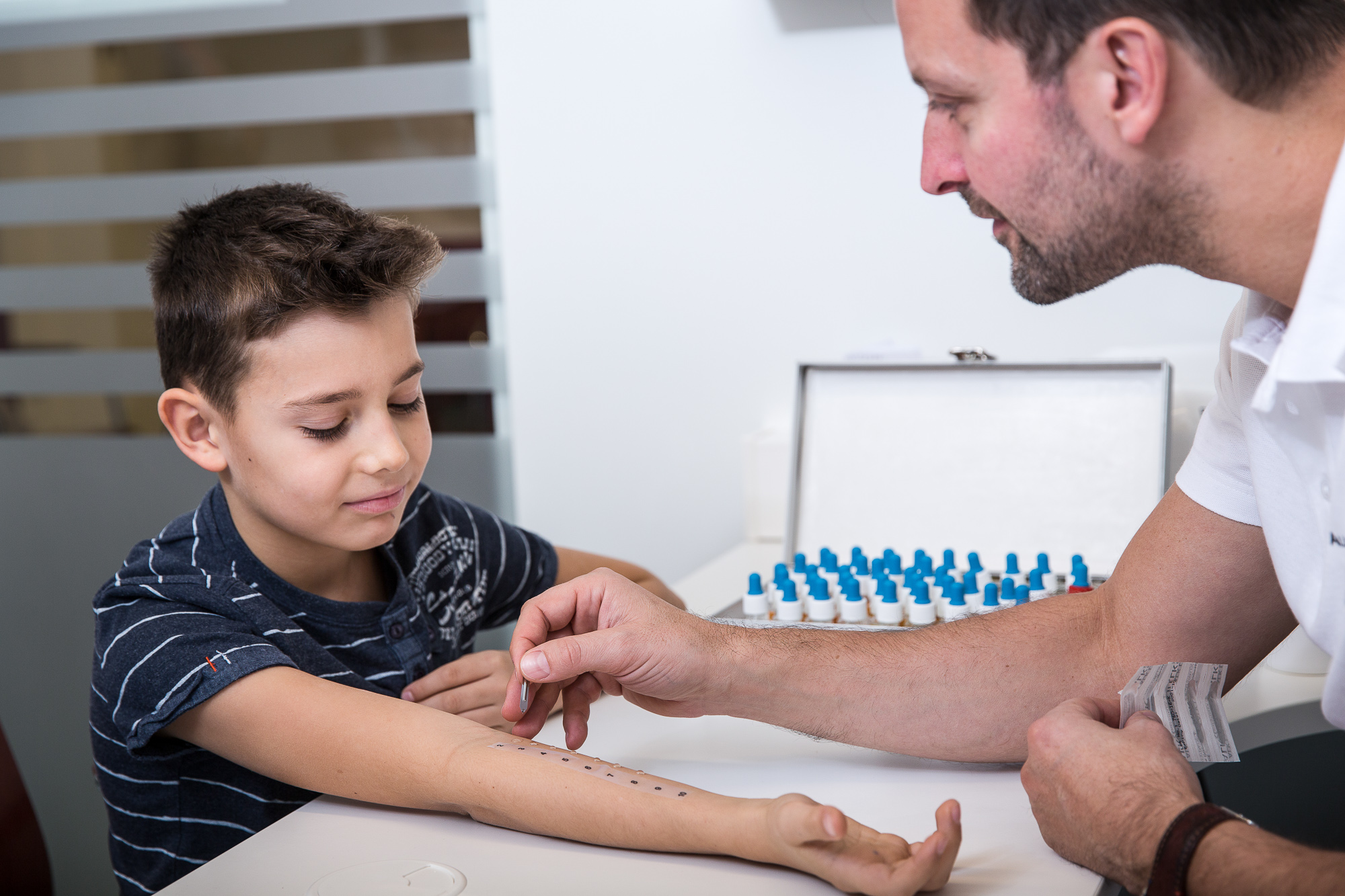A young boy bravely undergoing an allergen prick test, taking the first step towards understanding and managing his allergies for a healthier future