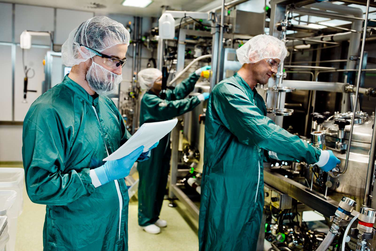Gowned workers in the production facility